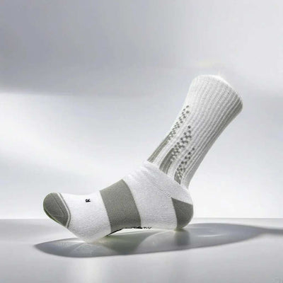 White and grey padel socks with reinforced cushioning for optimal grip and durability.